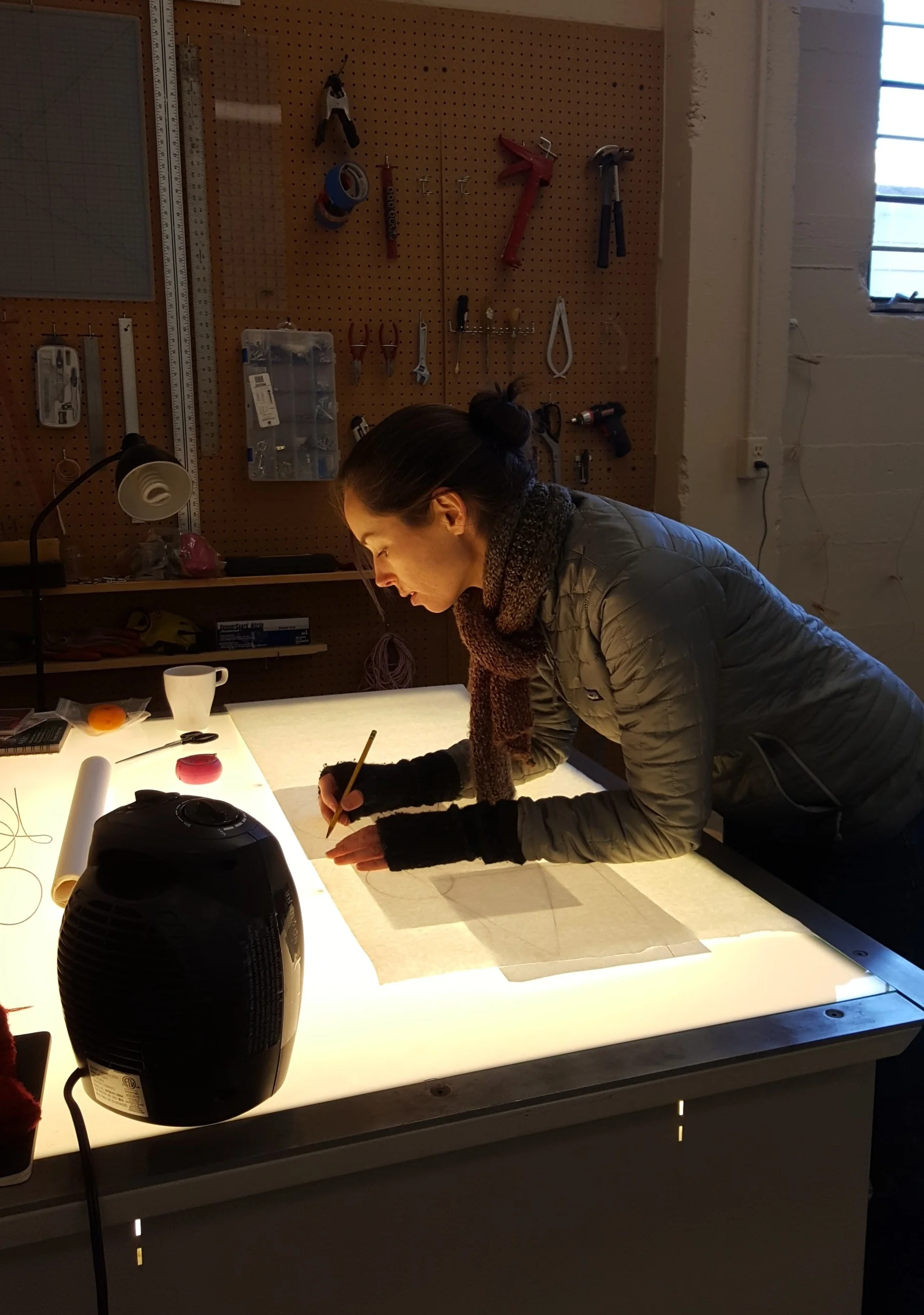 To go from idea to large-scale piece, I start by making a small felt pattern and stitch it together, trimming, changing, and restitching until I like it. Then I take it apart, trace the felt pattern onto paper, and scan the drawings. Then I digitally trace over the pattern using Adobe Illustrator, scale it up, and print it out. I use the light table to trace the pattern onto freezer paper, which will adhere temporarily to felt when I iron it on. 
