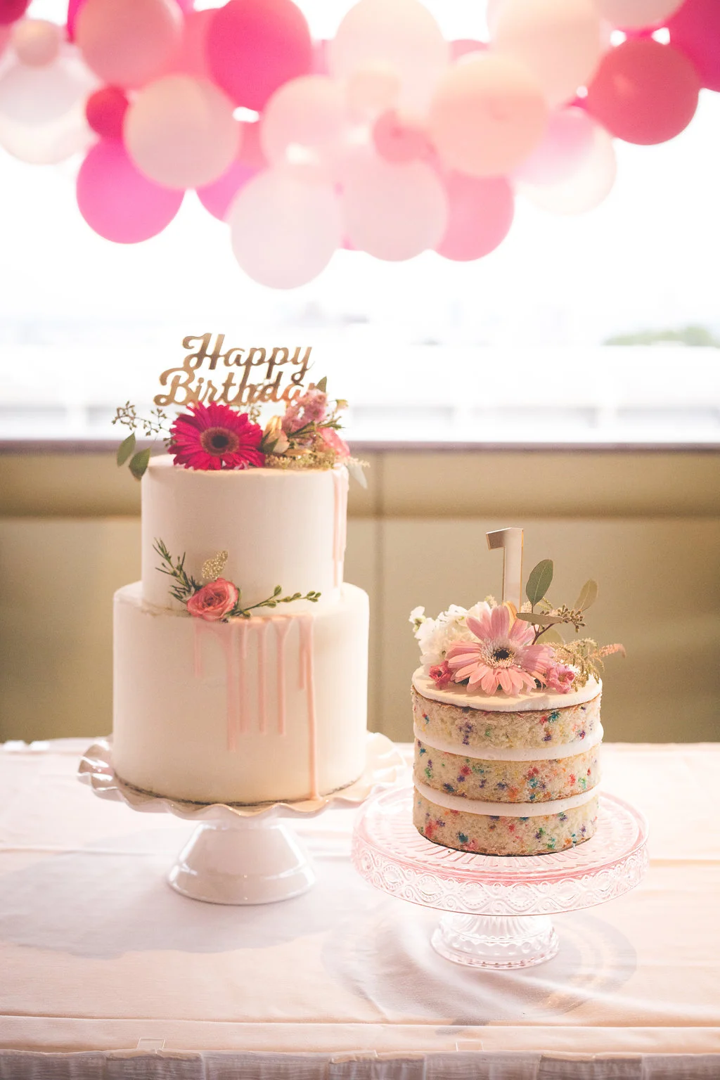 Cakes by Annie Bee Cakery, flowers by Willow Specialty Florist, and cake toppers by My Minds' Eye. 