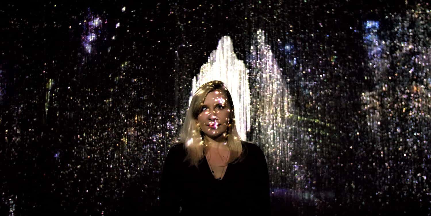 Artist Maja Petric's silhouette projected behind her in the interactive light installation.