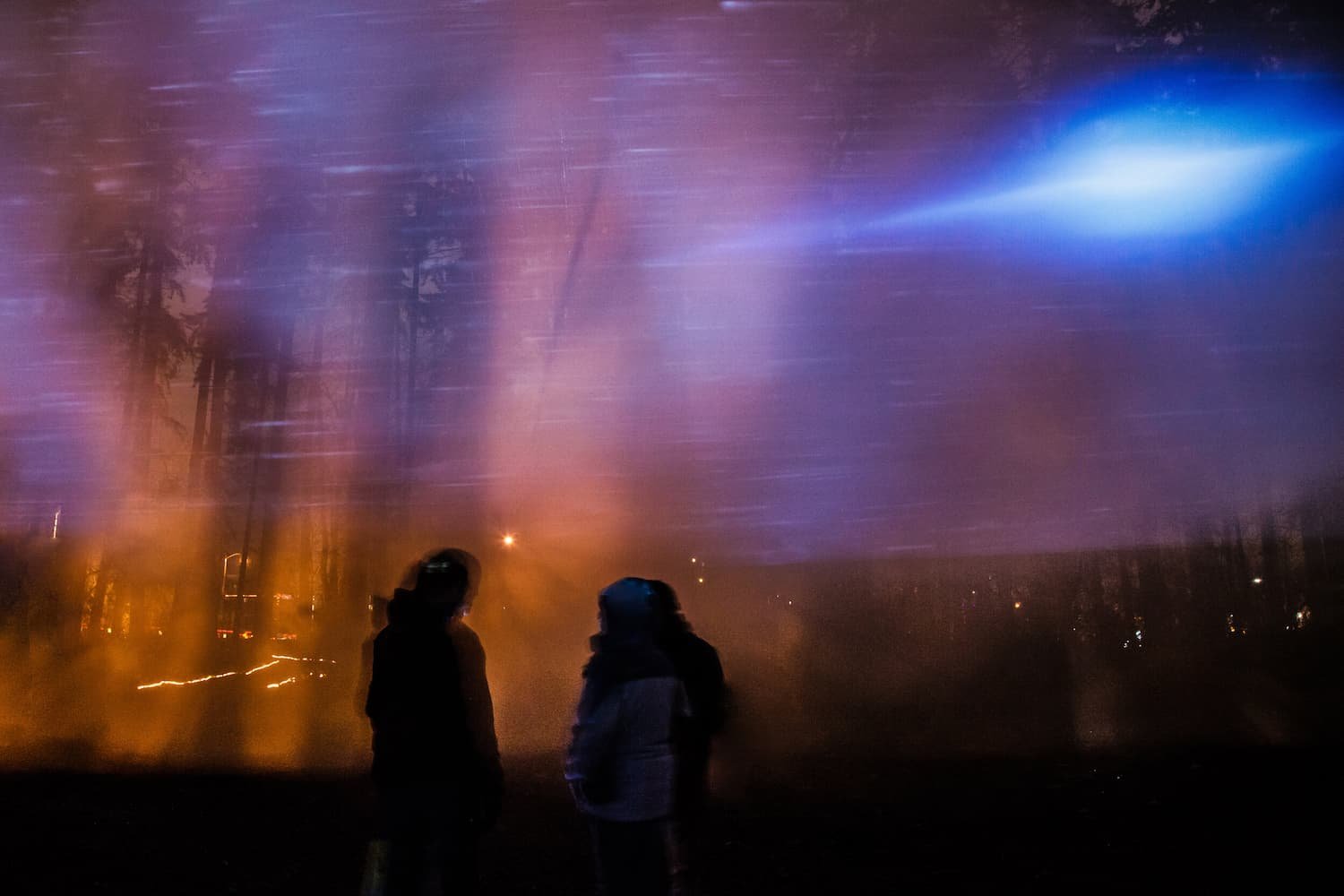 Visitors encountering an exploding blue light, representing the death of a person.