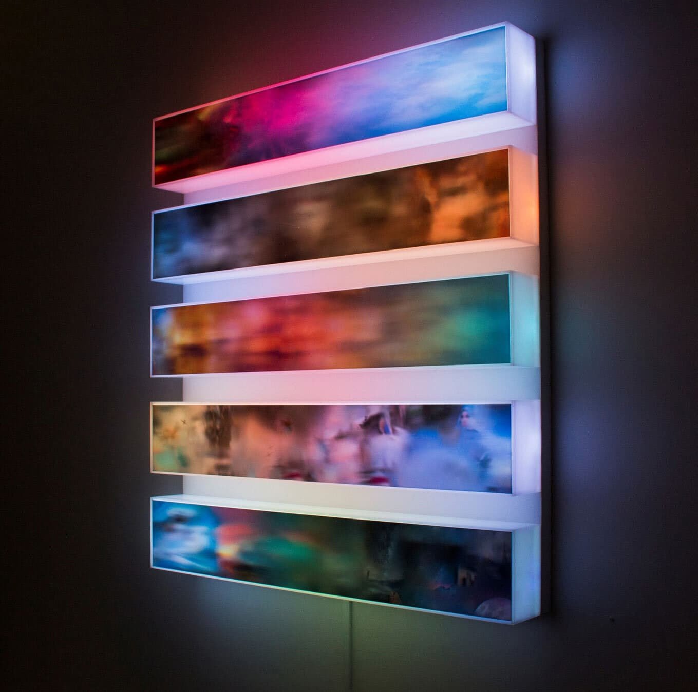 The dynamic light box depicting AI-generated views of the skies in 5 different areas of the world.