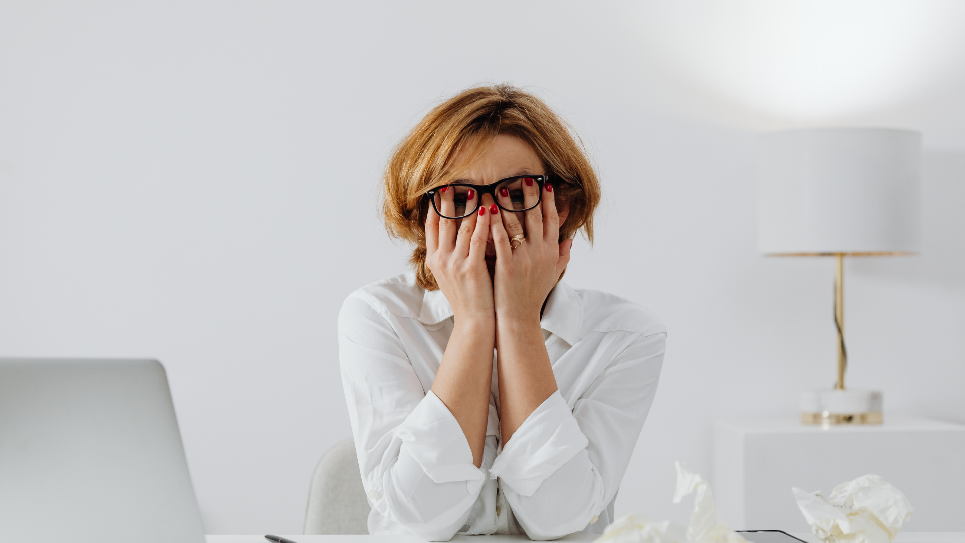Professional looking uncertain in a team meeting, highlighting how fear of judgement can prevent authentic expression