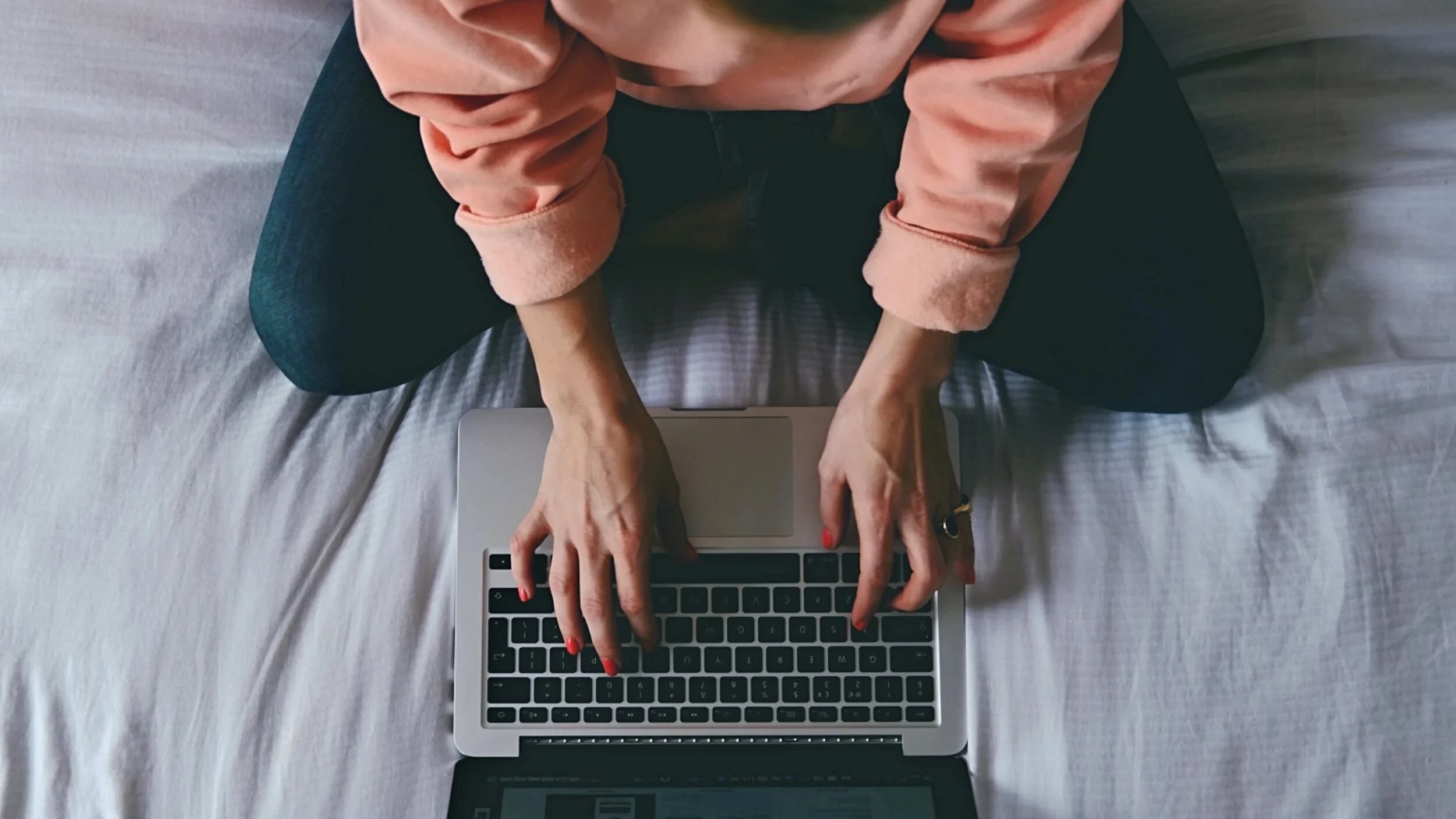 Kim Murray working on her laptop providing mental health and wellbeing coaching