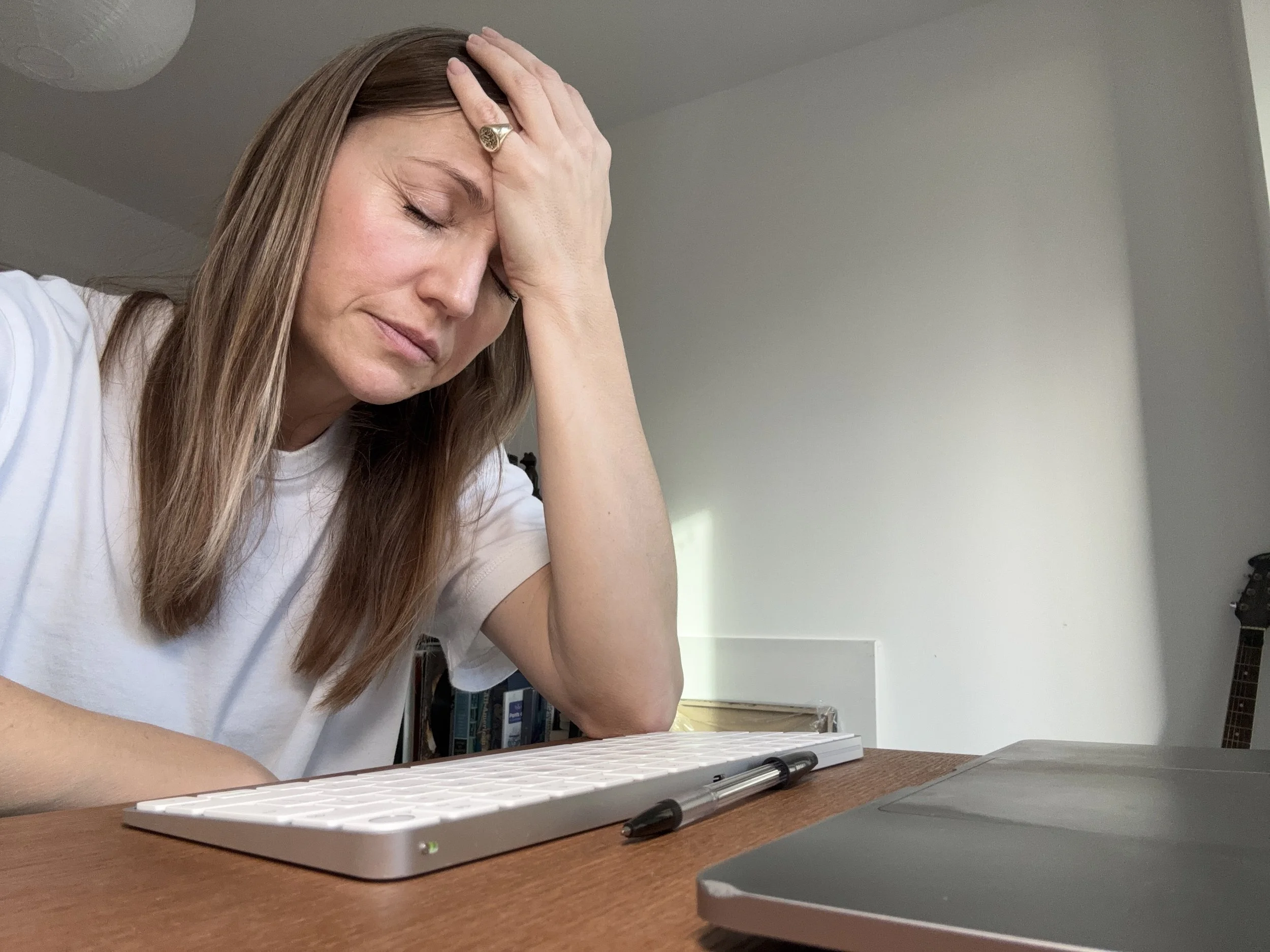 Woman appearing burnt out and overwhelmed, symbolising chronic stress and nervous system overload