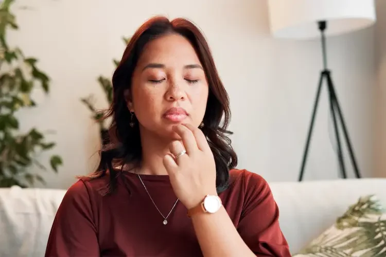 Woman practising EFT tapping to reduce stress and calm the nervous system