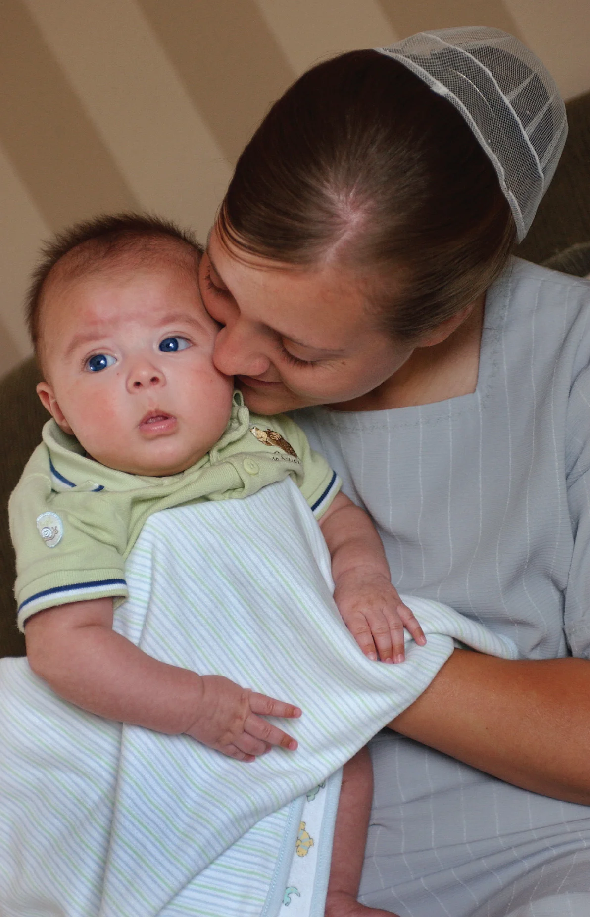 Foster parent tries to convince two month old Angelo in taking his afternoon nap.