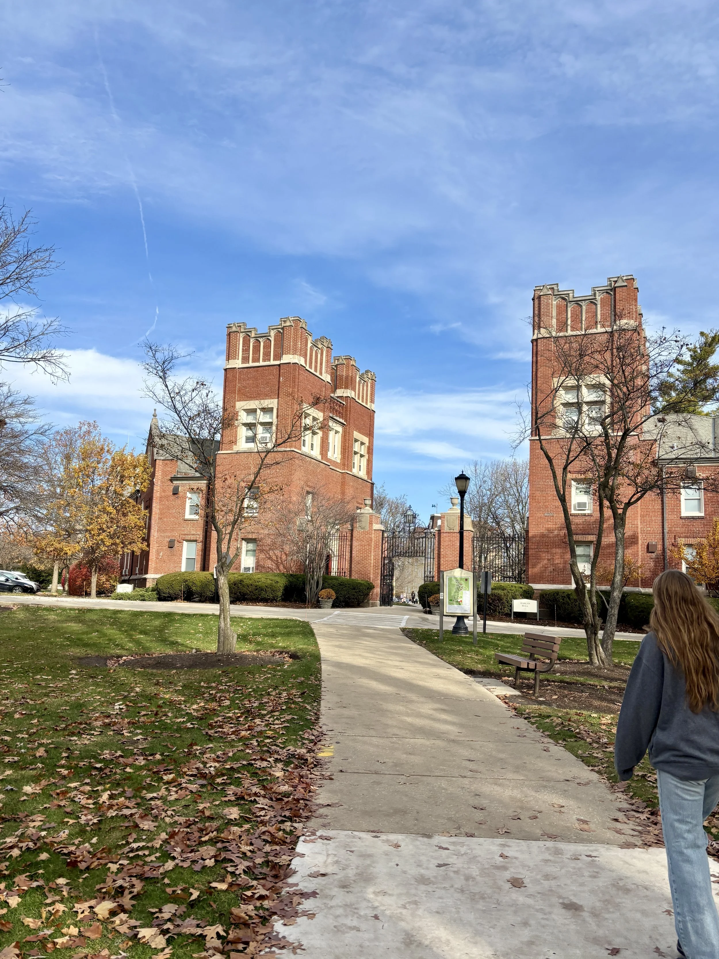 Girl approaching the gateway to the quad at Lake Forest College