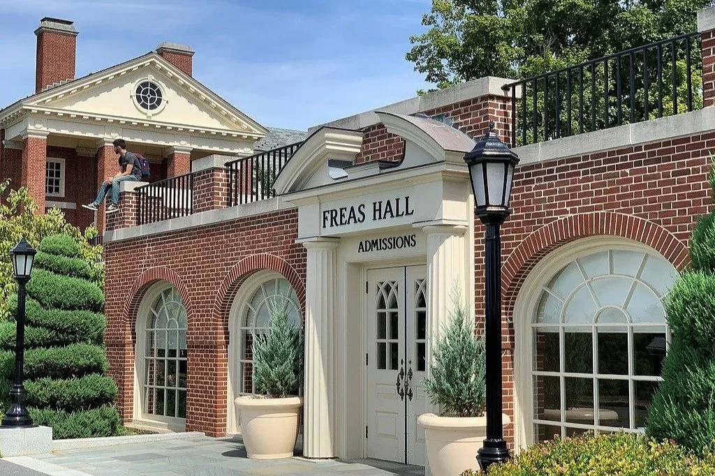 Image of a red brick admissions office on a college campus