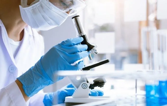 doctor looking in microscope