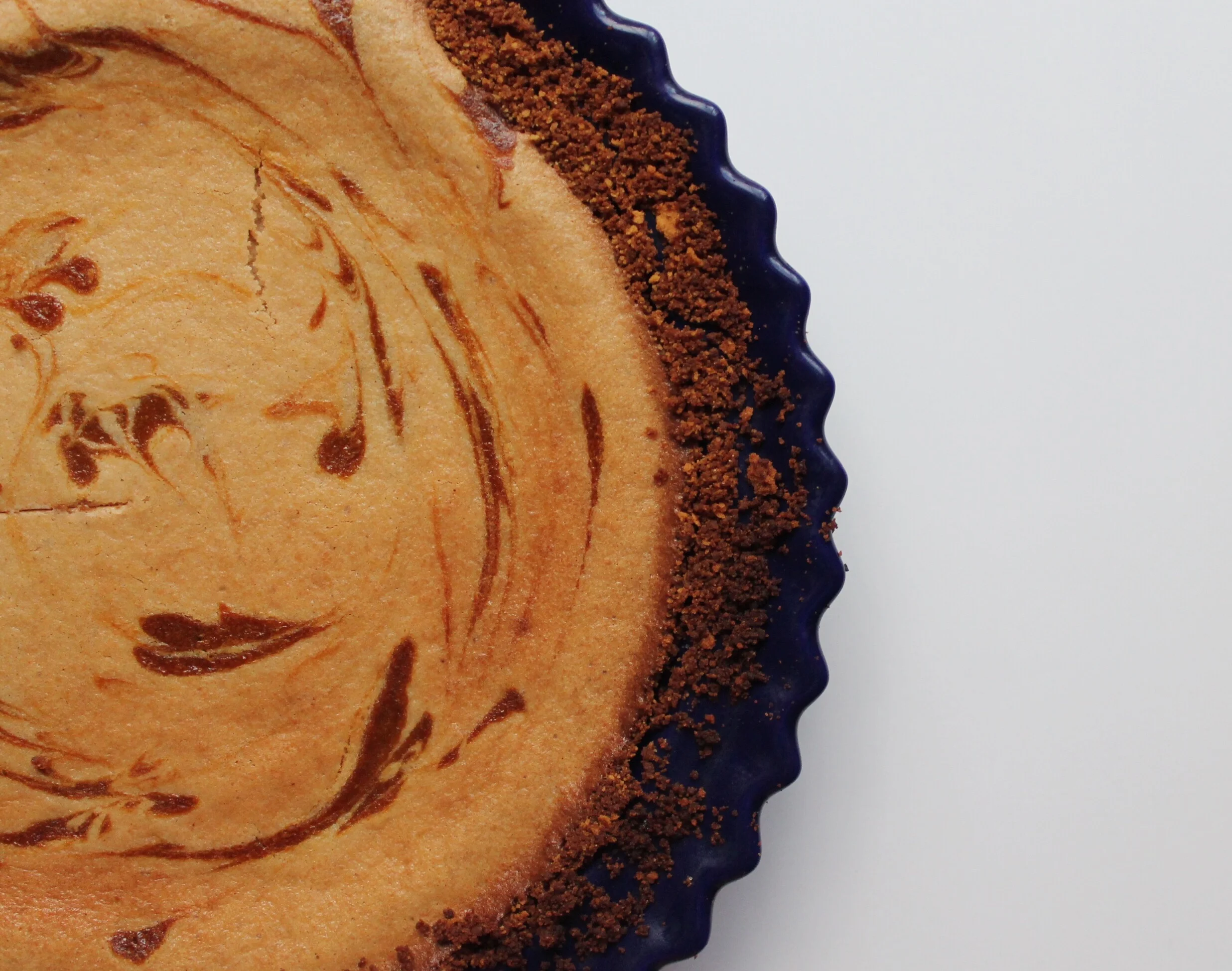 Pumpkin Swirl Cheesecake with a Molasses Cookie Crust
