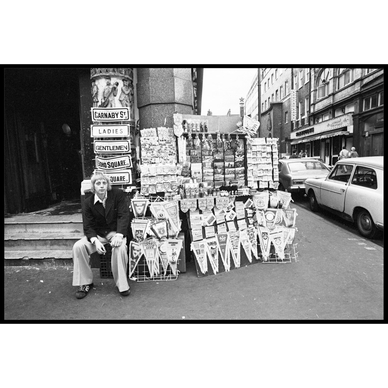 𝗧𝗶𝘁𝗹𝗲: 'London Vendor' | 𝗟𝗼𝗰𝗮𝘁𝗶𝗼𝗻: London, United Kingdom | 𝗬𝗲𝗮𝗿: 1975⁠