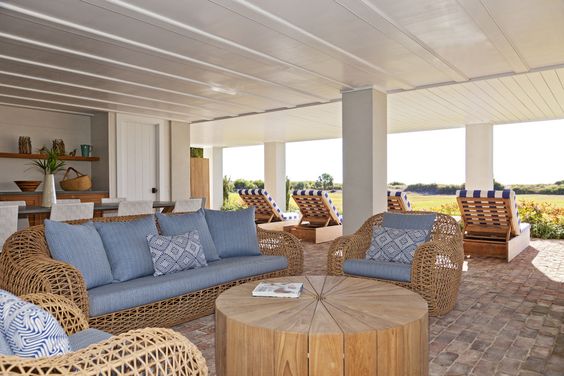 The breezy living room under the house includes an outdoor fireplace and bar, let the weekend begin!