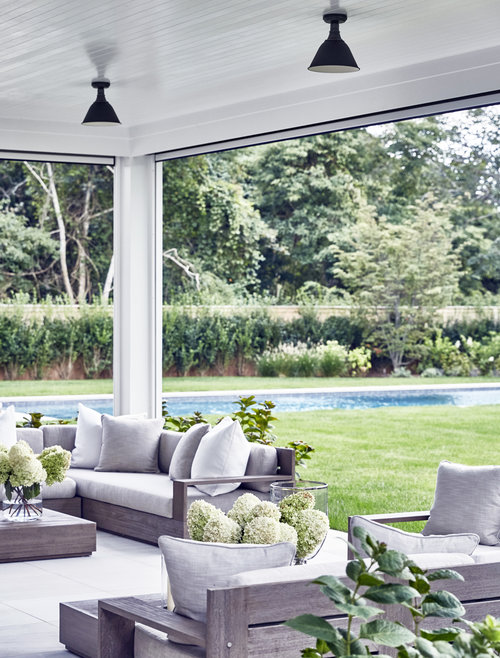 I love the fresh look Hydrangea blooms look in a large glass vase. The driftwood color of this teak outdoor furniture i s so natural and can be dressed up or down with cushions and pillows
