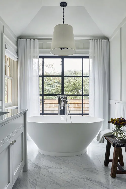 Elegant but casual spa-like bathrooms with white marble floors and shower...a luxurious way to end the day.