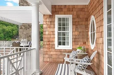 A lovely porch, inviting adirondack chairs to sit in and watch the sun say good night.
