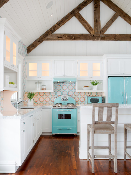 A crisp white kitchen with vintage-new appliances in aqua adds a splash of coastal vibe, and the pretty backsplash is so beachpretty! Via