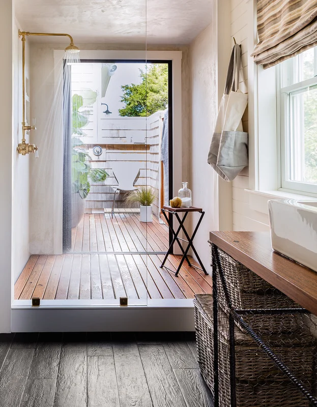 Lisa reworked the master bath layout to create connected indoor/outdoor showers — the ultimate luxury for communing with nature. Waterproof plaster clads the shower. Coney Island boardwalk planks have new life as vanity countertops and shower floors.
