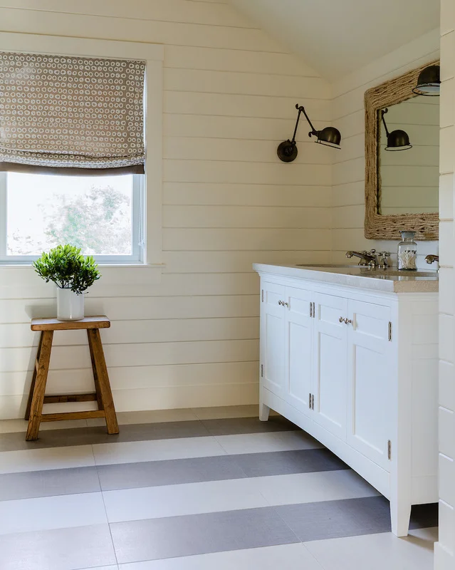 Guest Bedroom is all textures, wrapped in navy grasscloth. Floor tile in the Children's Bath mimics a striped beach blanket.