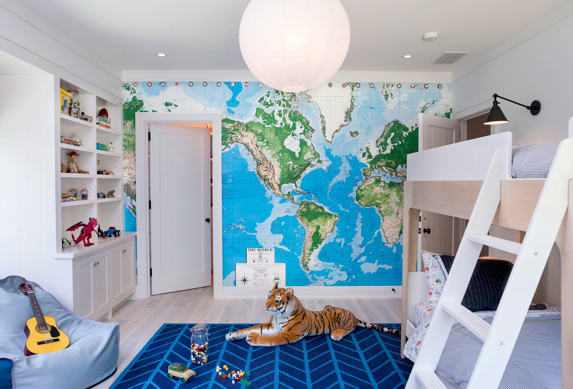 As your little boy plays with his guitar he can look at the map on the wall and sing about places he will travel to someday. Similar map mural here .
