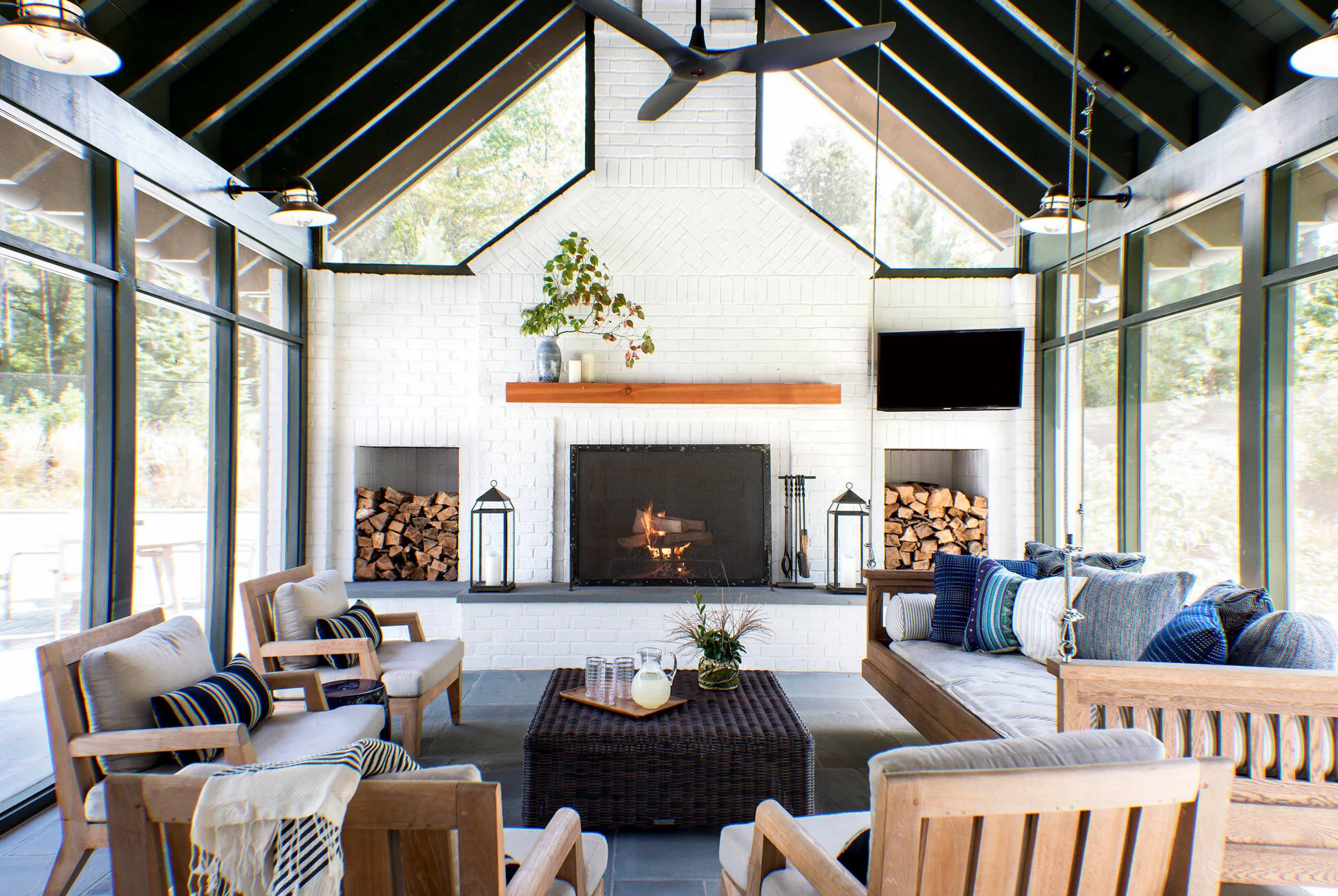 I am obsessed with this sun room, I would spend evenings on the grand swing and sit by the fire with a few of my favorite friends, this room is on my wish list, you? Similar Vintage Porch Swing, here . For more inspiration, visit The Outdoor Living Shop .