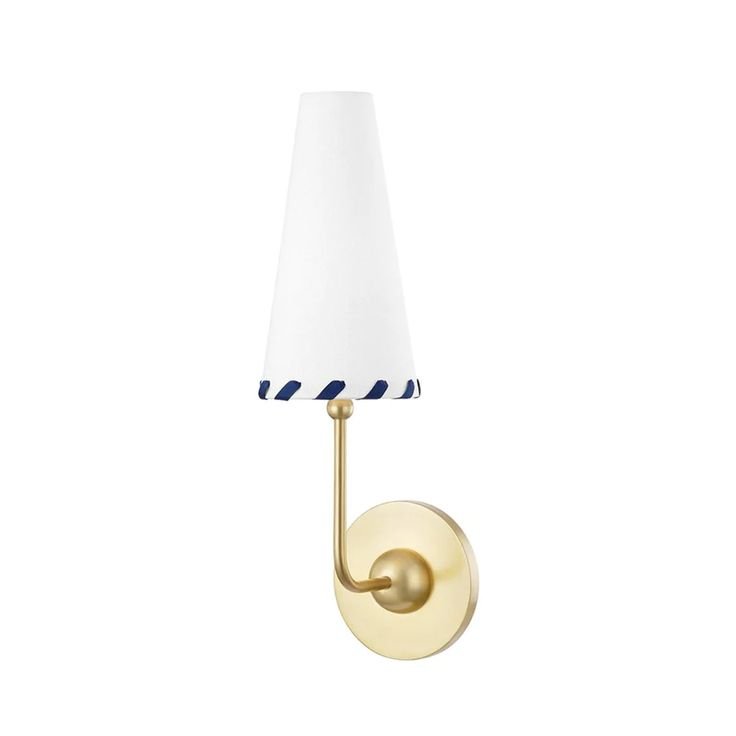  Our Cherie Sconce features classic styling, perfect for transitional interiors. A Belgian linen shade is accented with navy ribbon whipstitch detailing, for visual appeal. This versatile wall sconce is available in aged brass or polished nickel fini