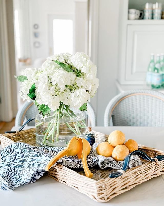 Coastal Kitchen Decor Featuring White Hydrangeas and Woven Tray