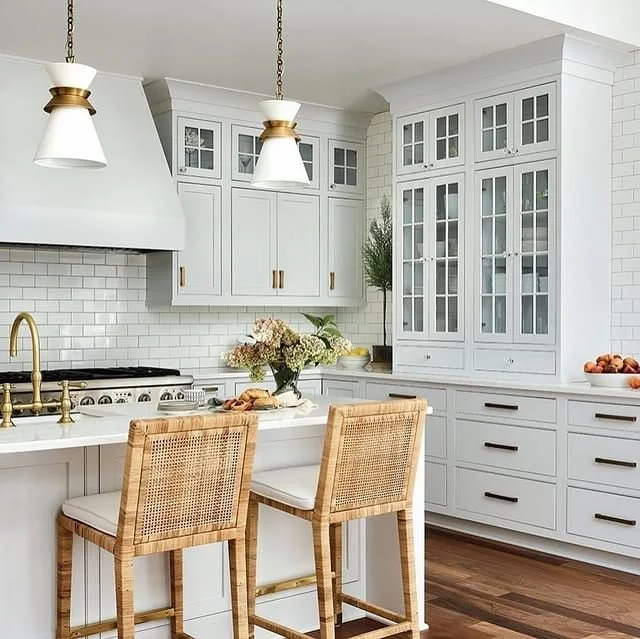 Classic Coastal Kitchen with White Cabinetry and Woven Bar Stools