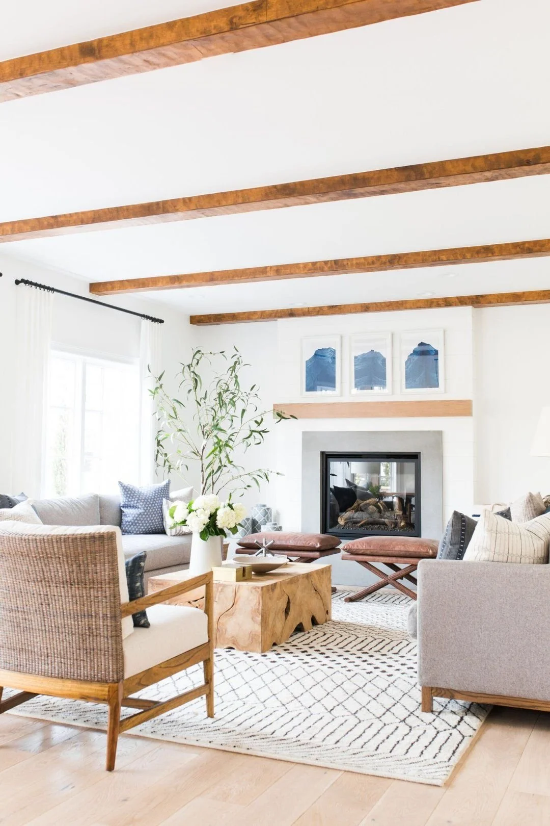 Modern Coastal Living Room with Exposed Wood Beams and Firepla