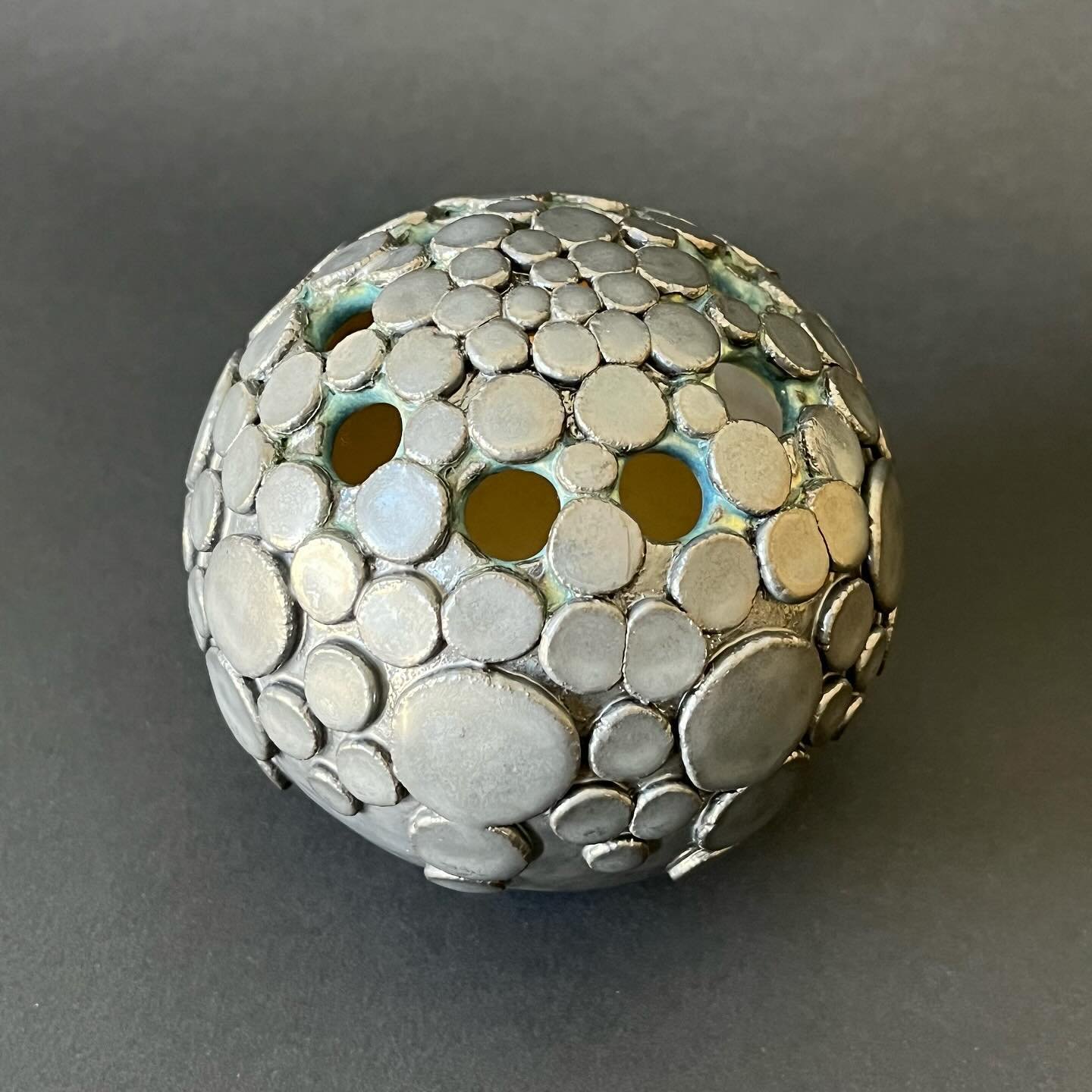 Making art sometimes feels like remembering a language I haven&rsquo;t spoken in a while. Although this new metallic-glazed 3.75&rdquo; vessel seems a little different than my recent work, I realized I started creating texture from pressed discs at l