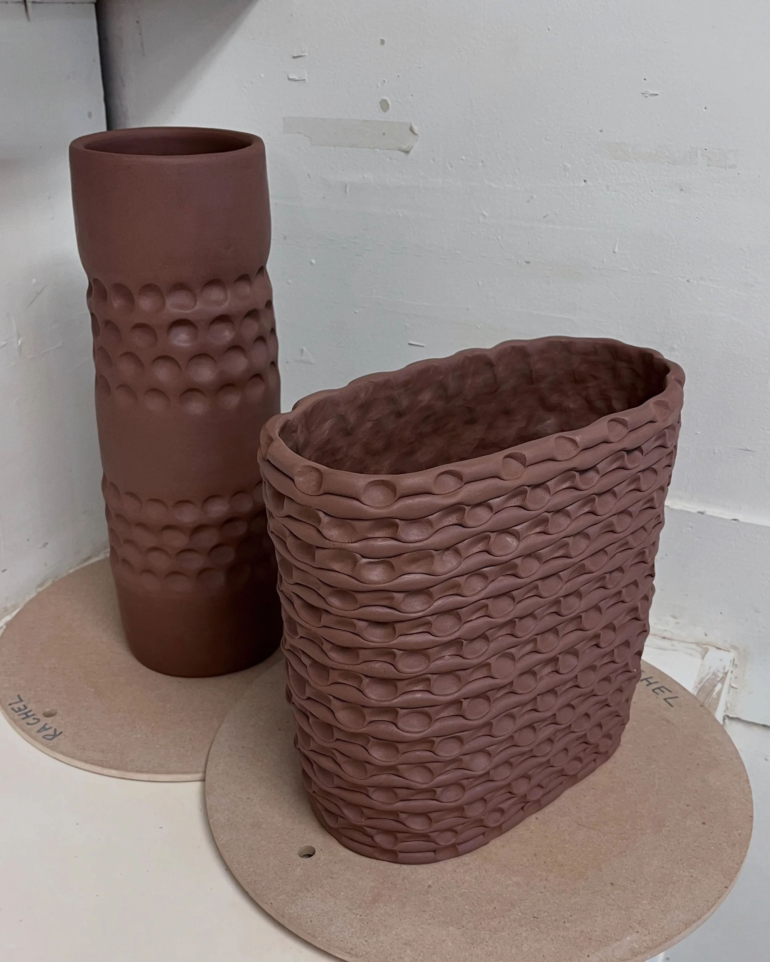Works in progress. I dared myself to make a tall vessel (14&rdquo; on the left) and an oval shape using my favorite technique of the moment&mdash;coiling and pinching to create a textured pattern (on the right). Stay tuned for firing results.

#Handm