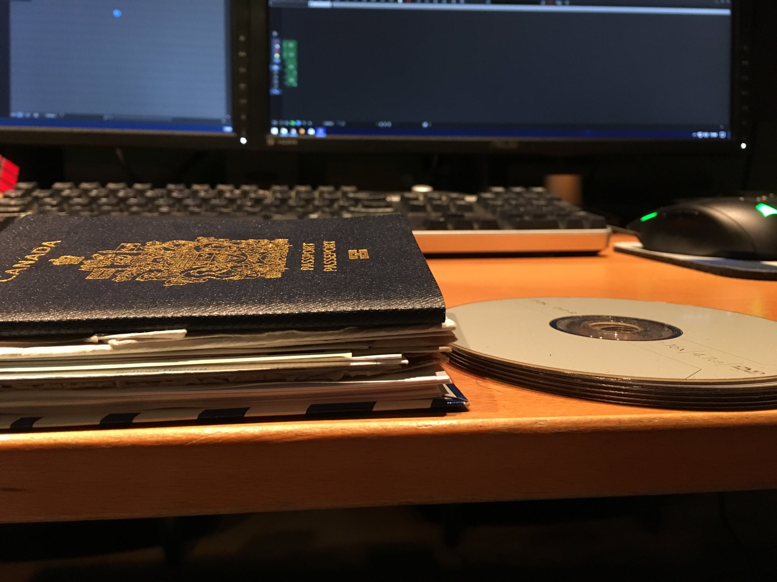 All the needed papers next to five DVDs for scale. It's thicker than the desk!