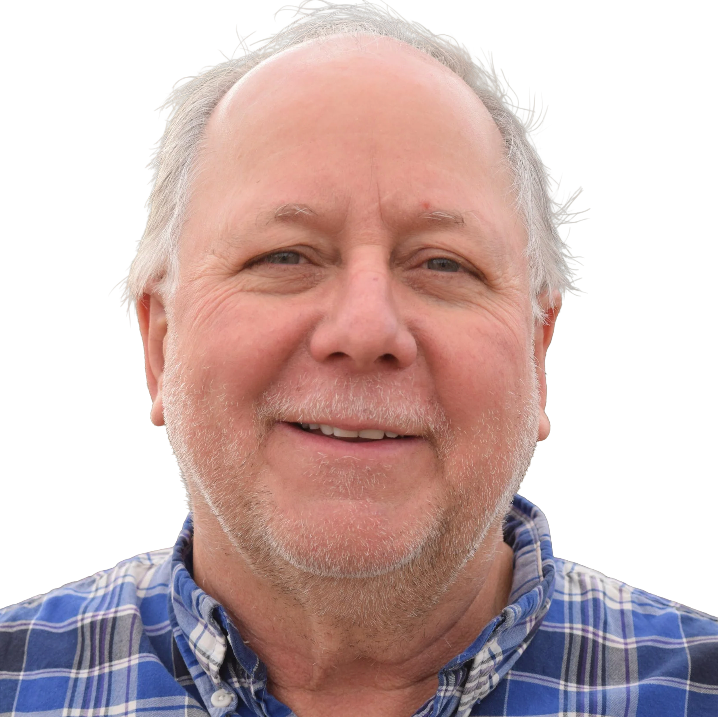 Close-up of smiling older man with gray hair and beard, wearing a blue plaid shirt.