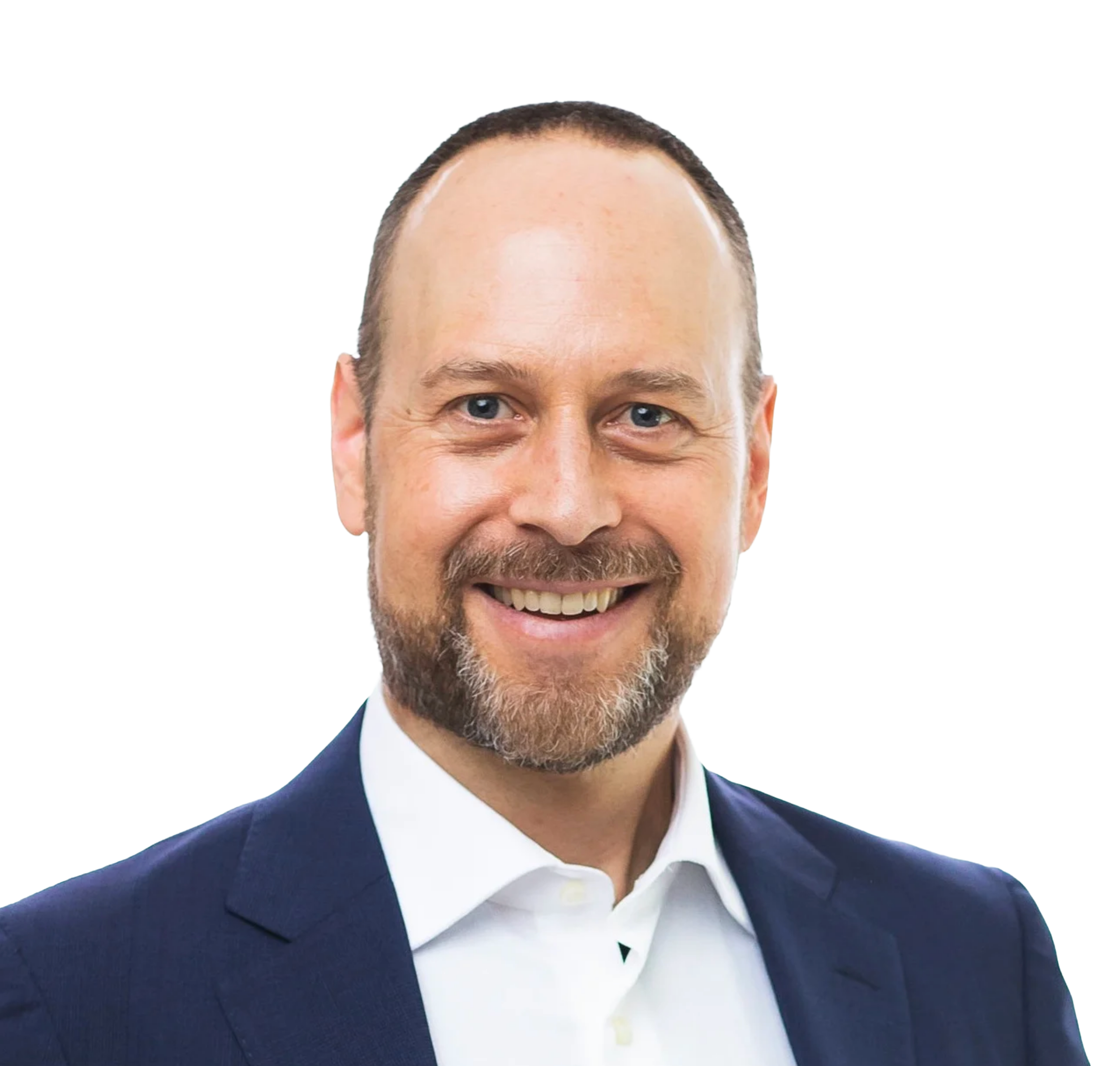 A smiling man with a short beard, wearing a navy blue suit and white shirt.