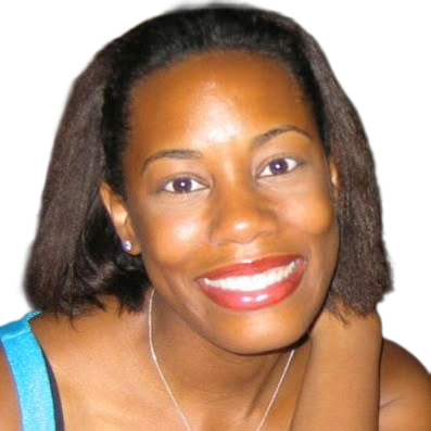 Close-up of a woman smiling, wearing a blue top and silver necklace, with short dark curly hair.
