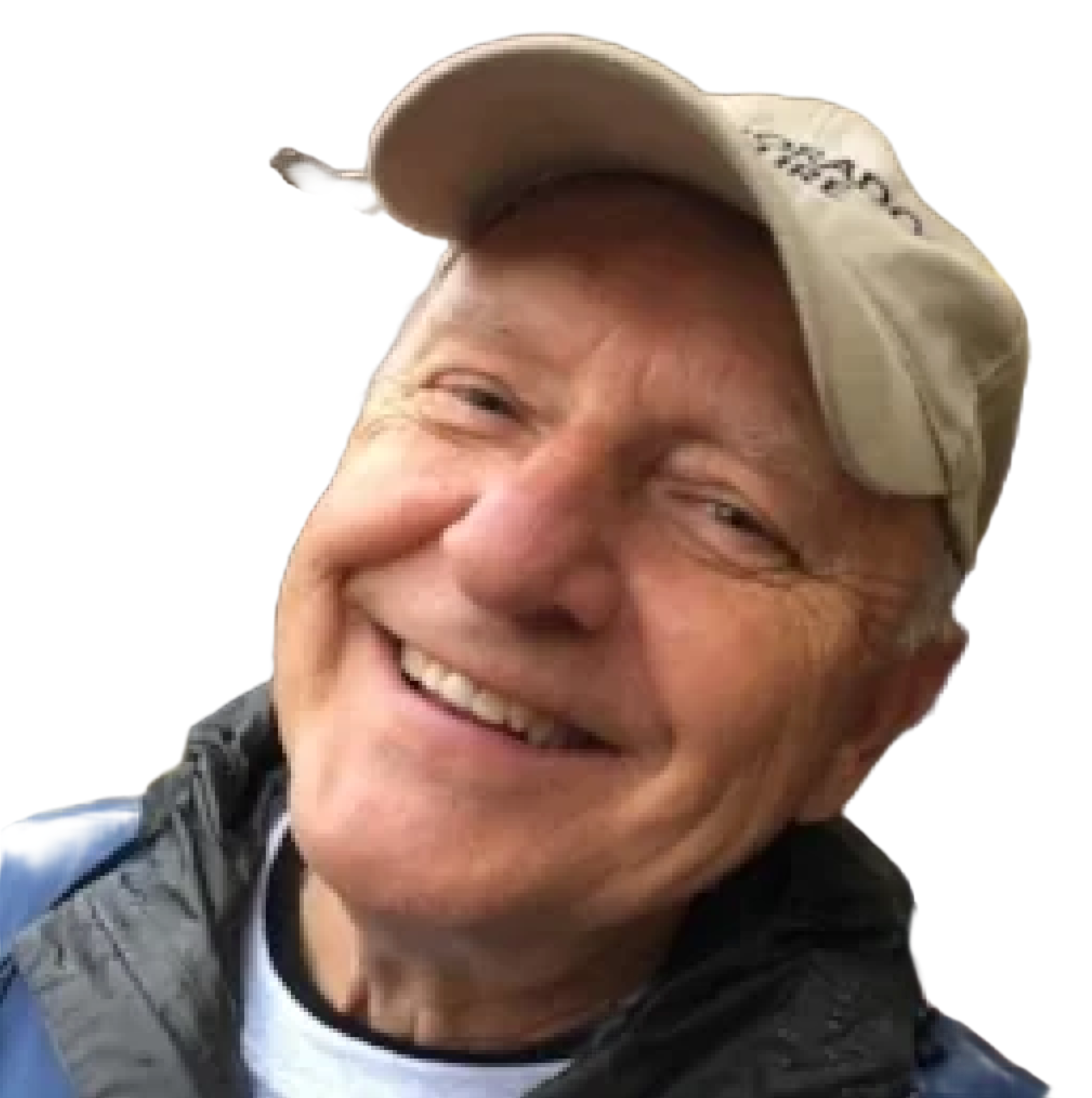 Close-up of a smiling man wearing a beige cap and a blue jacket.