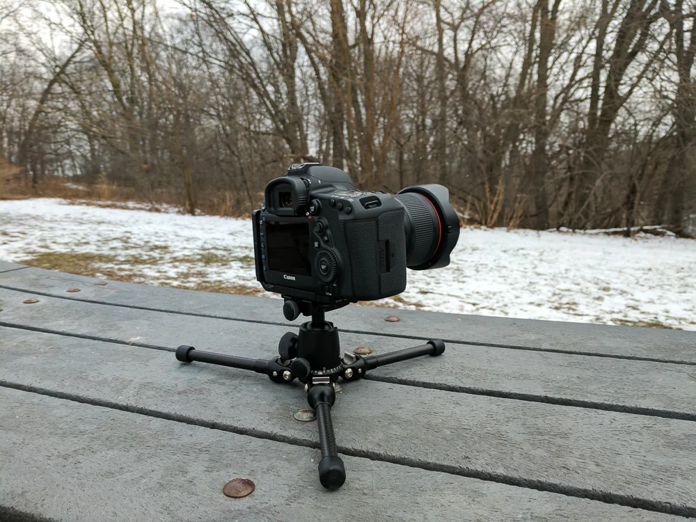 Tripod legs splayed flat on the ground