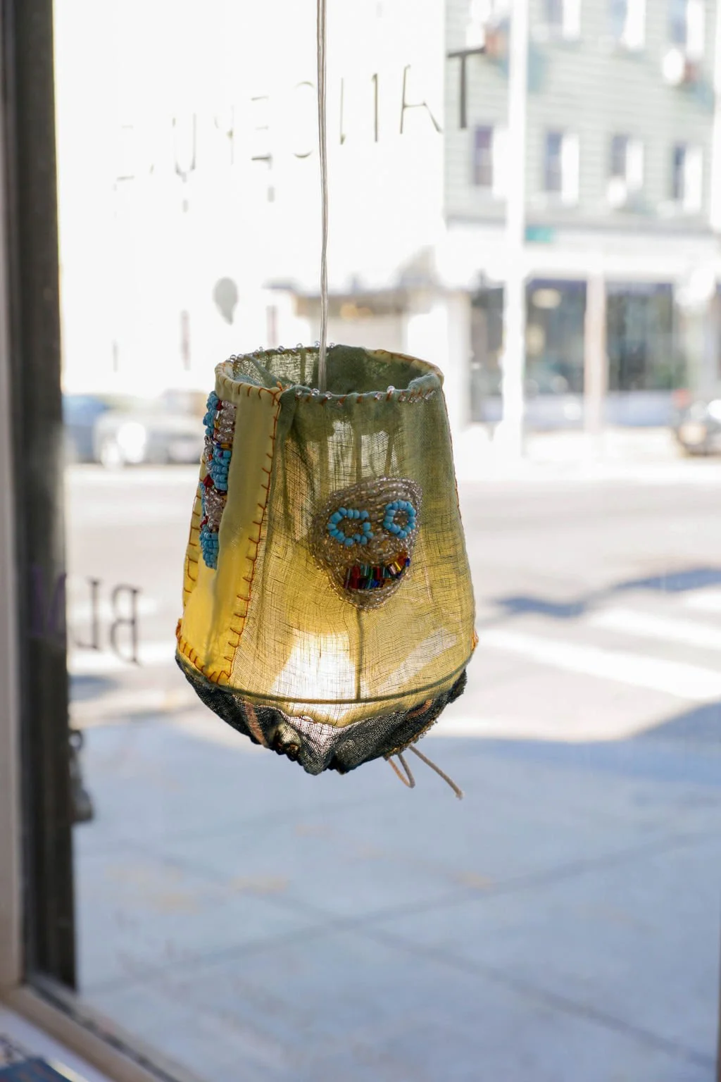  Sarah Nsikak   Moon Phases , 6.5 x 5 in., Vintage textiles, glass beads, hand spun cotton twine, 2023  SN0002  Price Upon Request  Sarah Nsikak is an emerging textile artist and designer living and working in Brooklyn. This special collection of pat