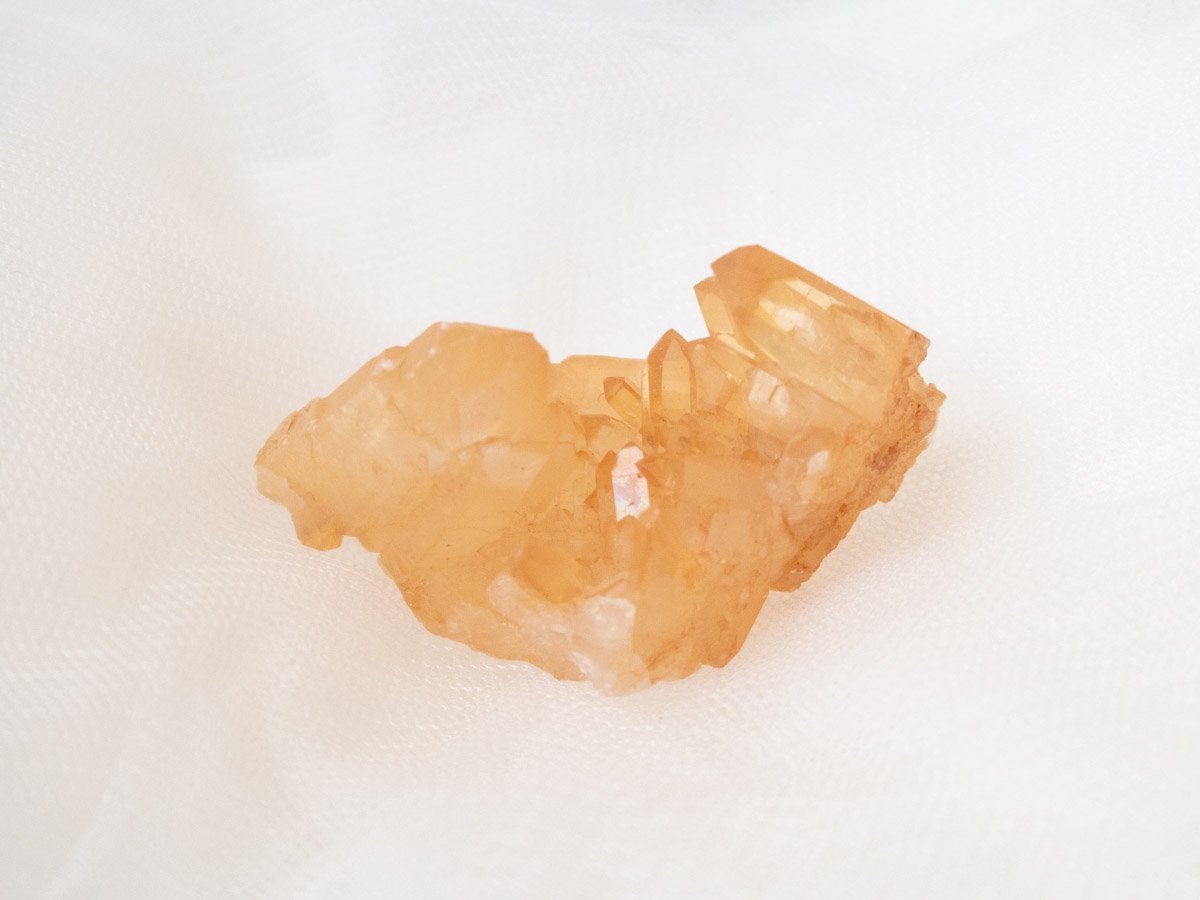 Tangerine quartz cluster A: Smaller piece with many, smaller points, and a darker orange colour
