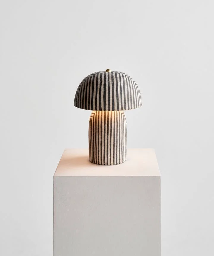 Striped table lamp with a mushroom shape on a pedestal