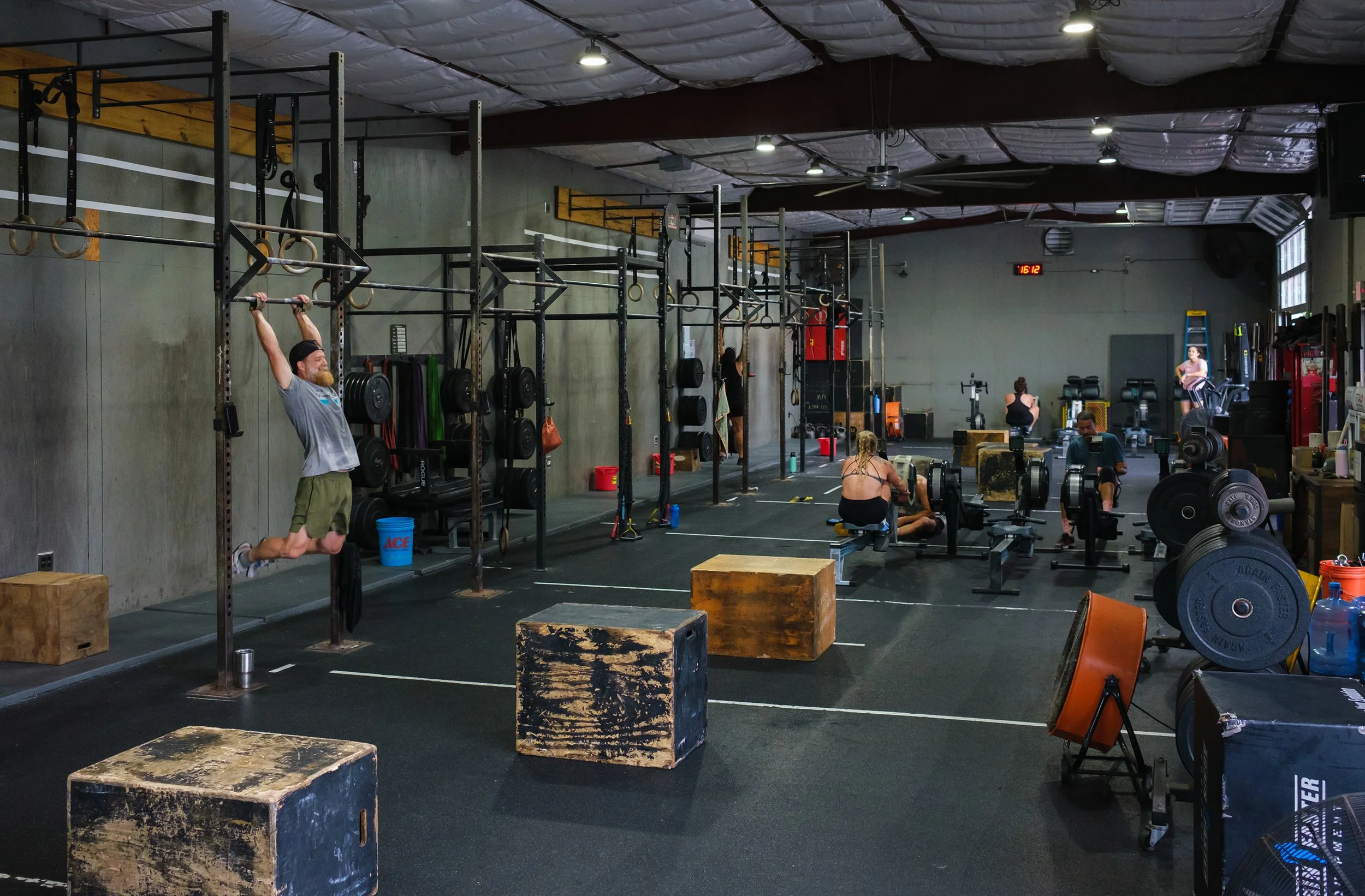The training floor at Crucible CrossFit: turf, plyo boxes and members mid-workout.