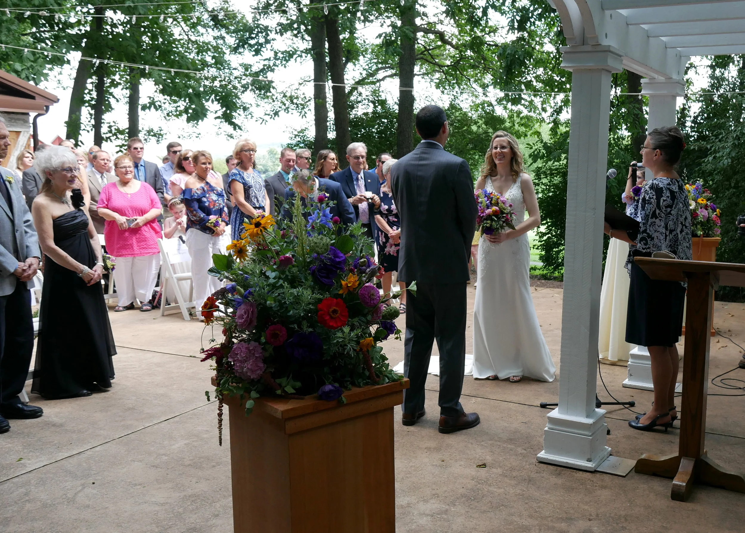Family members built these altar flower stands that were perfect for holding these lush summer arrangements