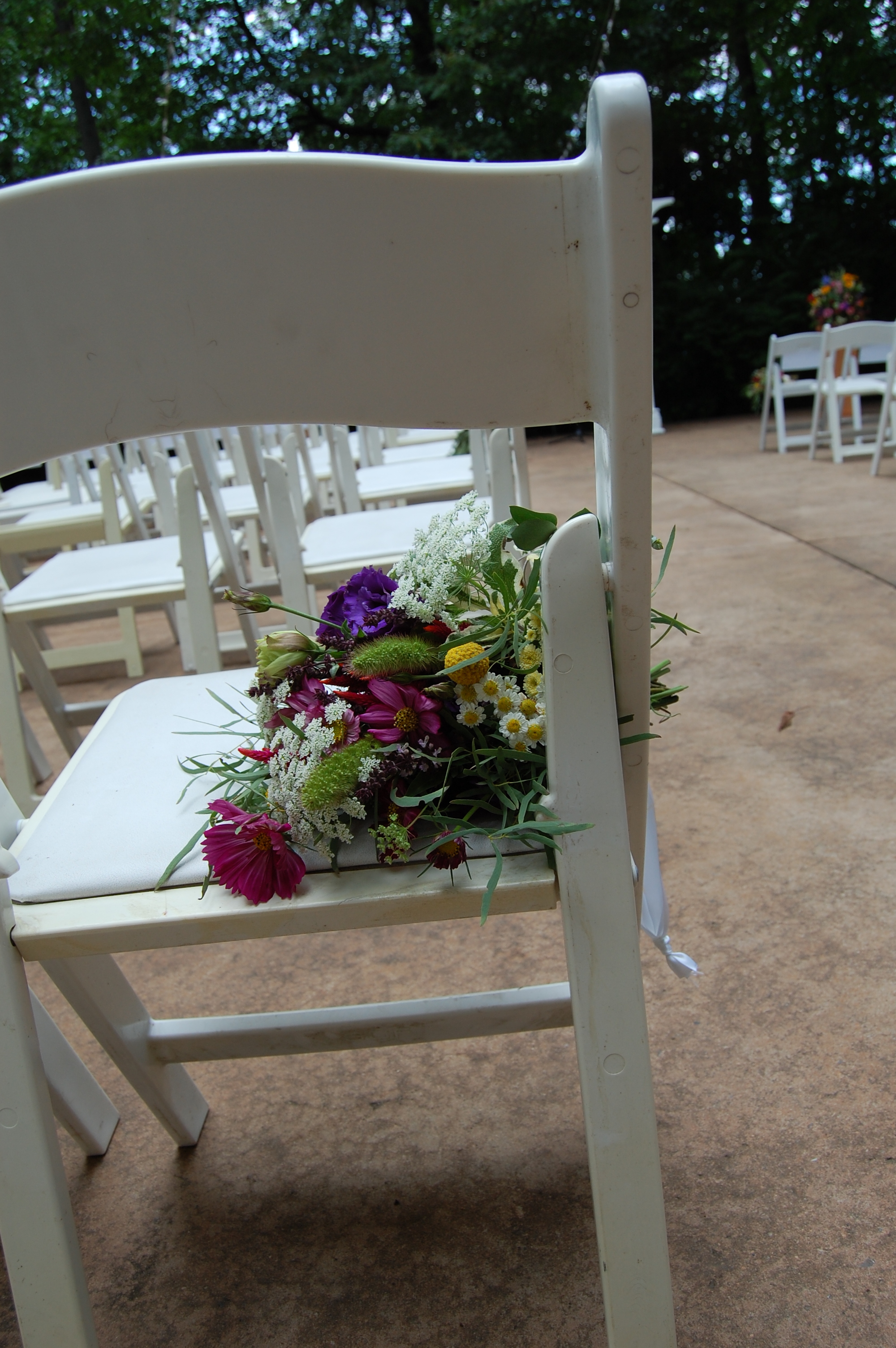 Wildflower bunches hung from the chairs bordering the aisle
