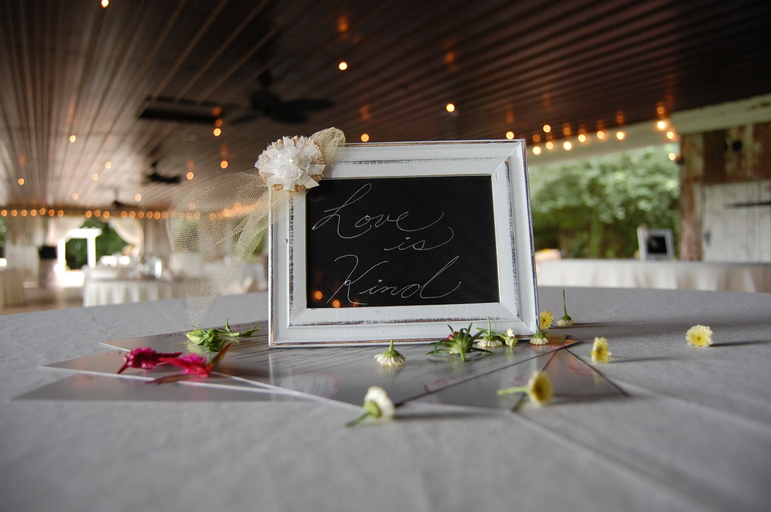 A fun reception décor idea we don't see too often, Margie had scattered flower petals on all the guests tables as centerpieces