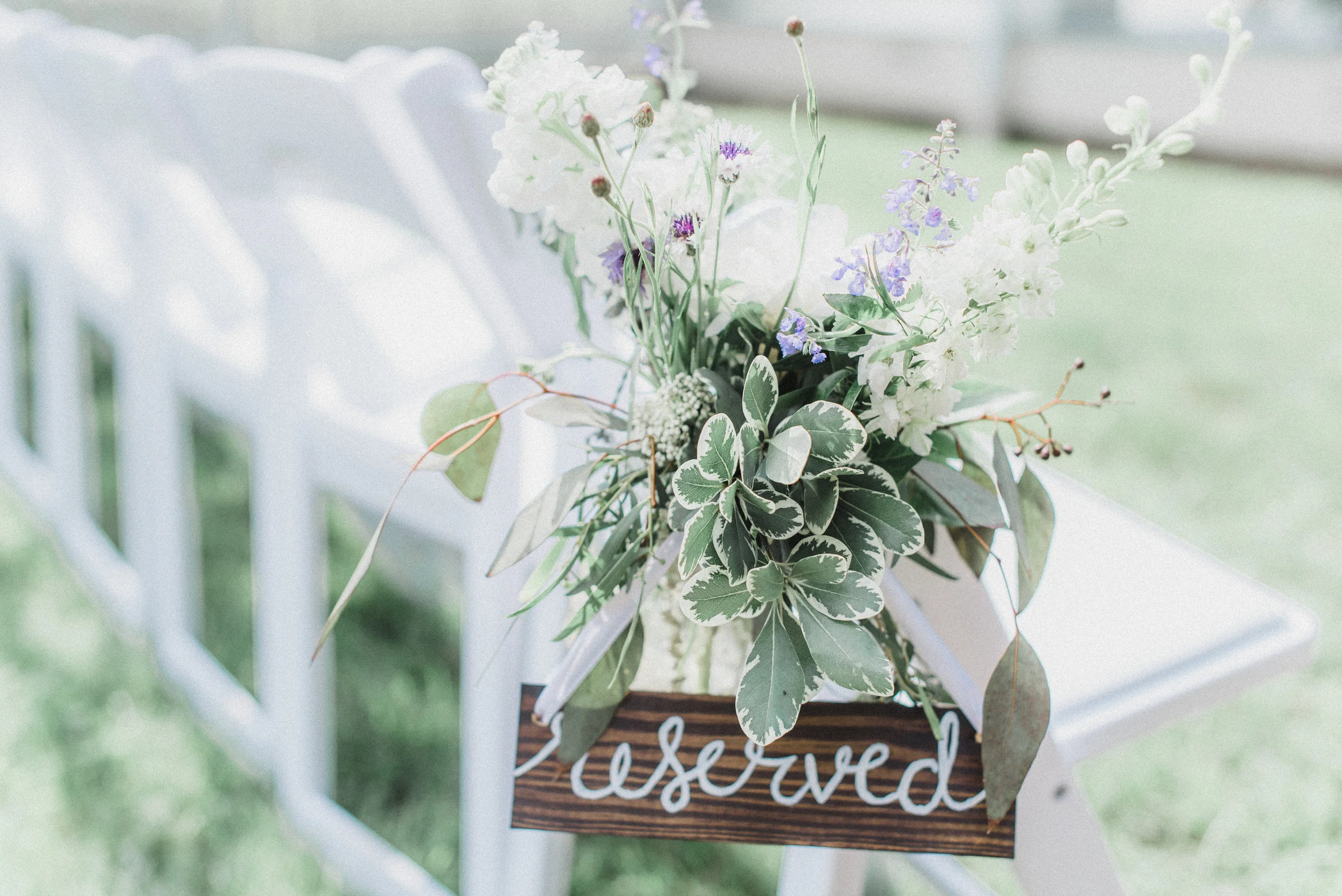 Ceremony detail: Hanging flower jar row markers