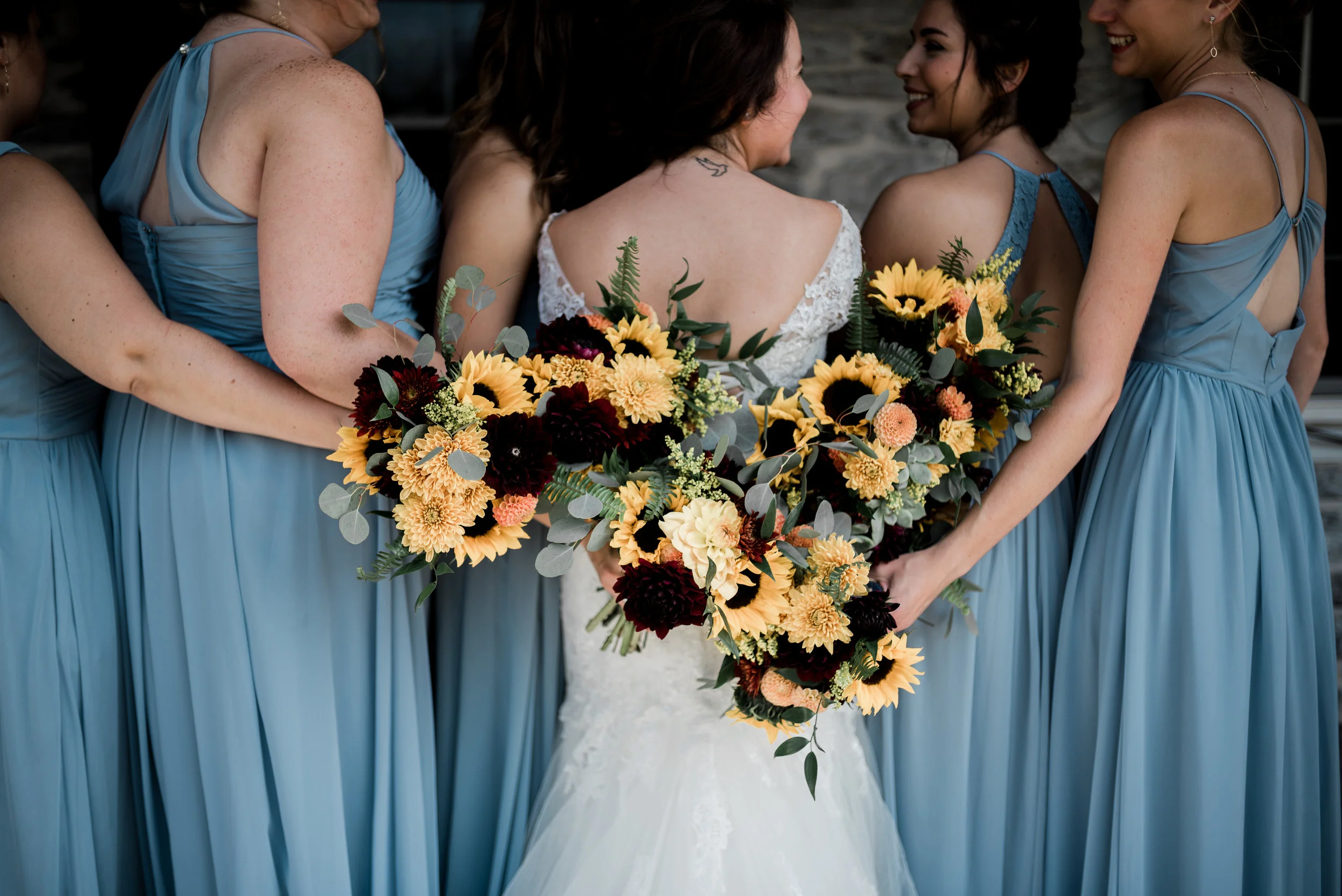 We love the contrast of the warm fall colors with the cool slate blue dresses