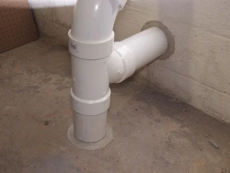 We seal the opening around the pipe.