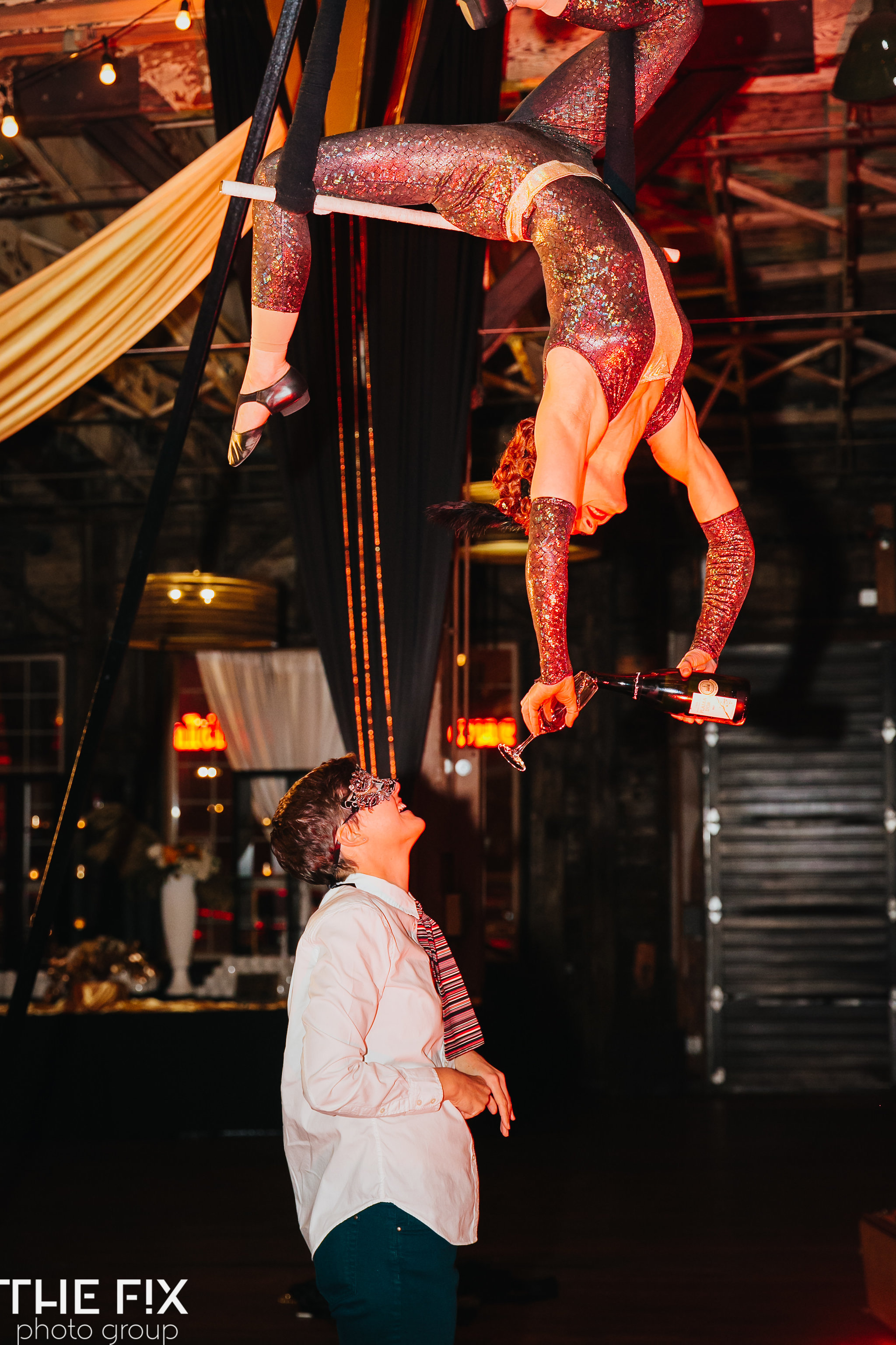 aerialists at a Corporate holiday party entertainment at Herban Feast , photographed by the Fix Photo Group