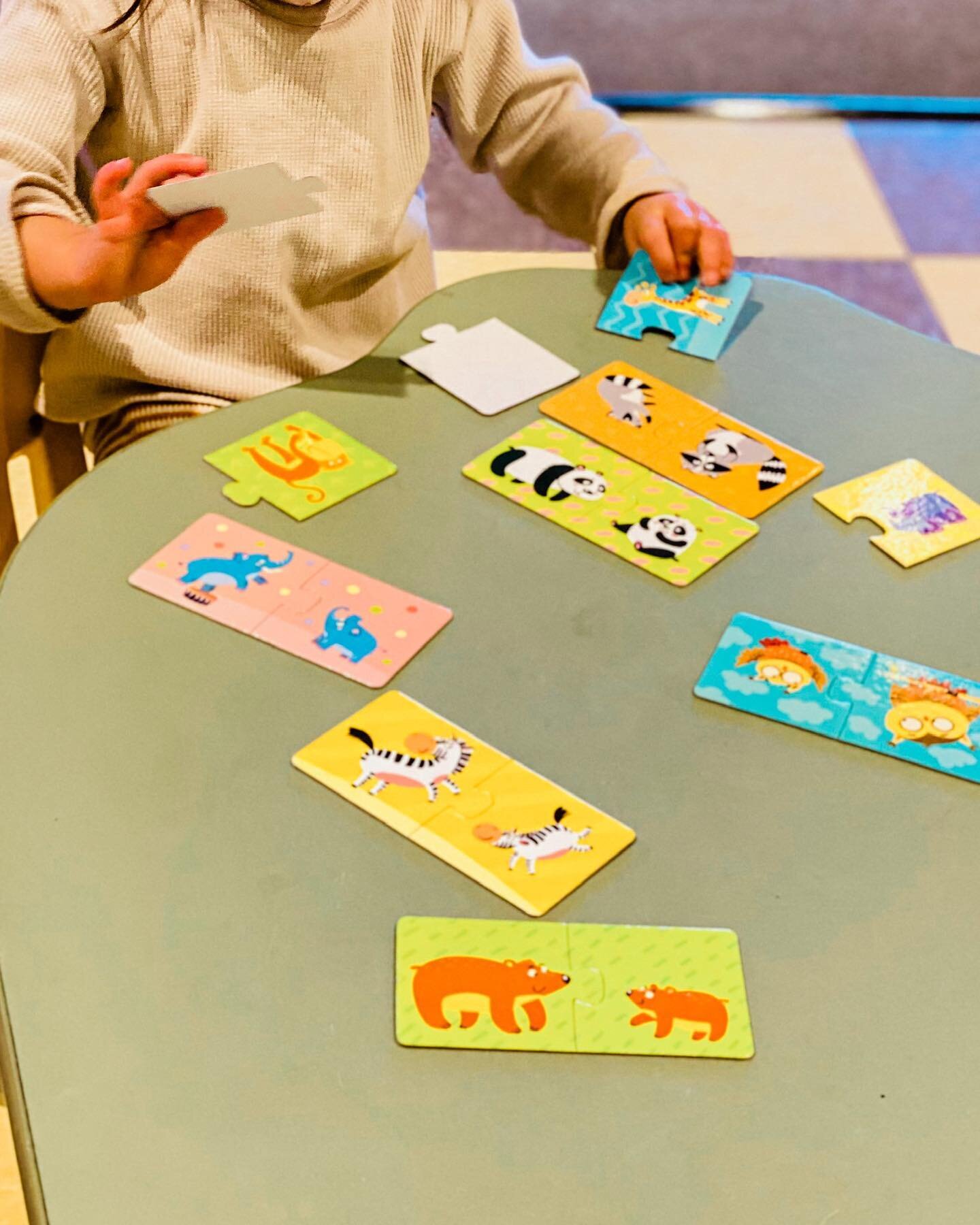 Putting together all the pieces to these puzzling pairs is promoting educational play.

Image Description: A student sits at a green table putting together a puzzle. Some pieces have an adult animal and others have a baby animal to be matched.

#pres
