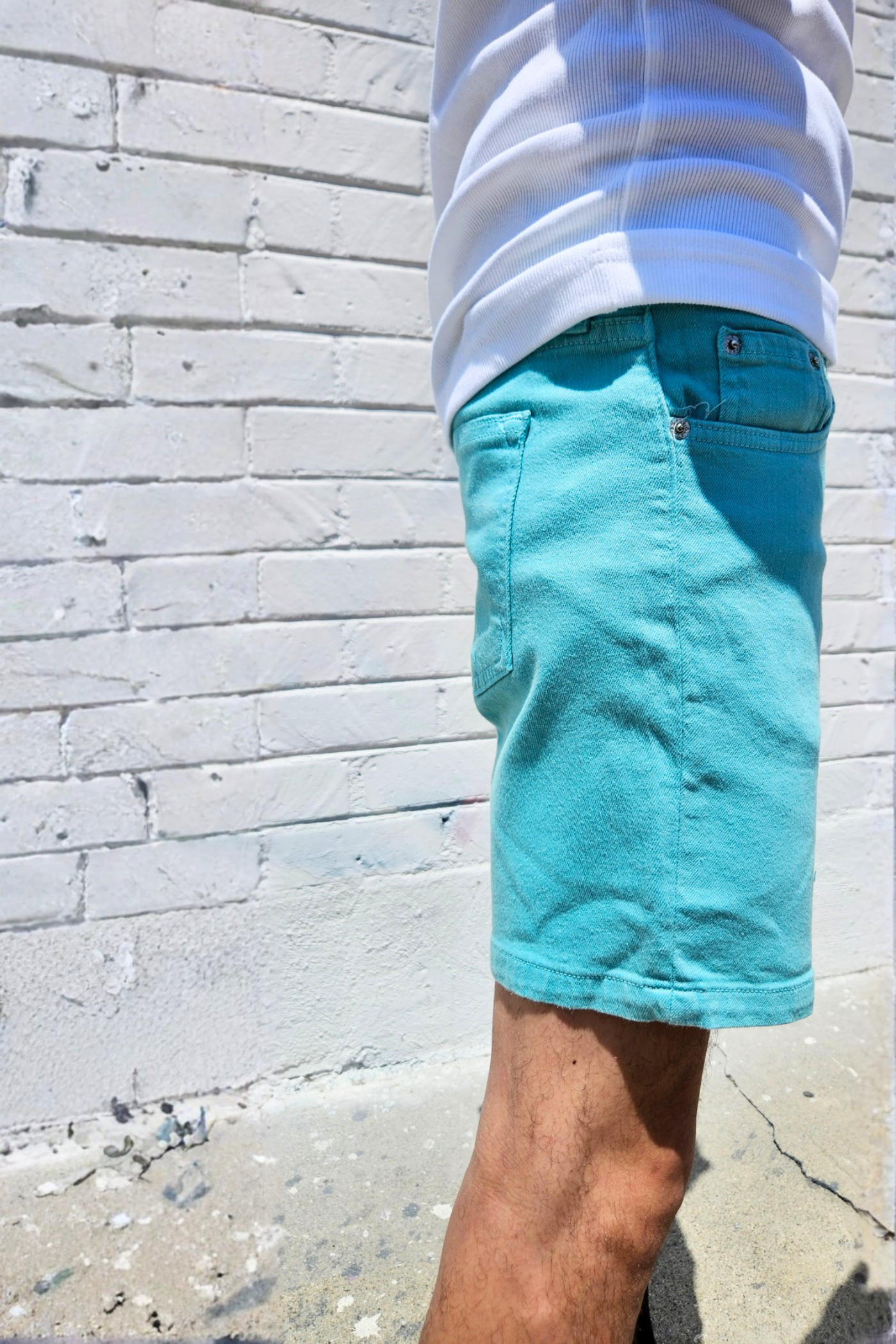 Teal summer shorts featuring an above knee length.