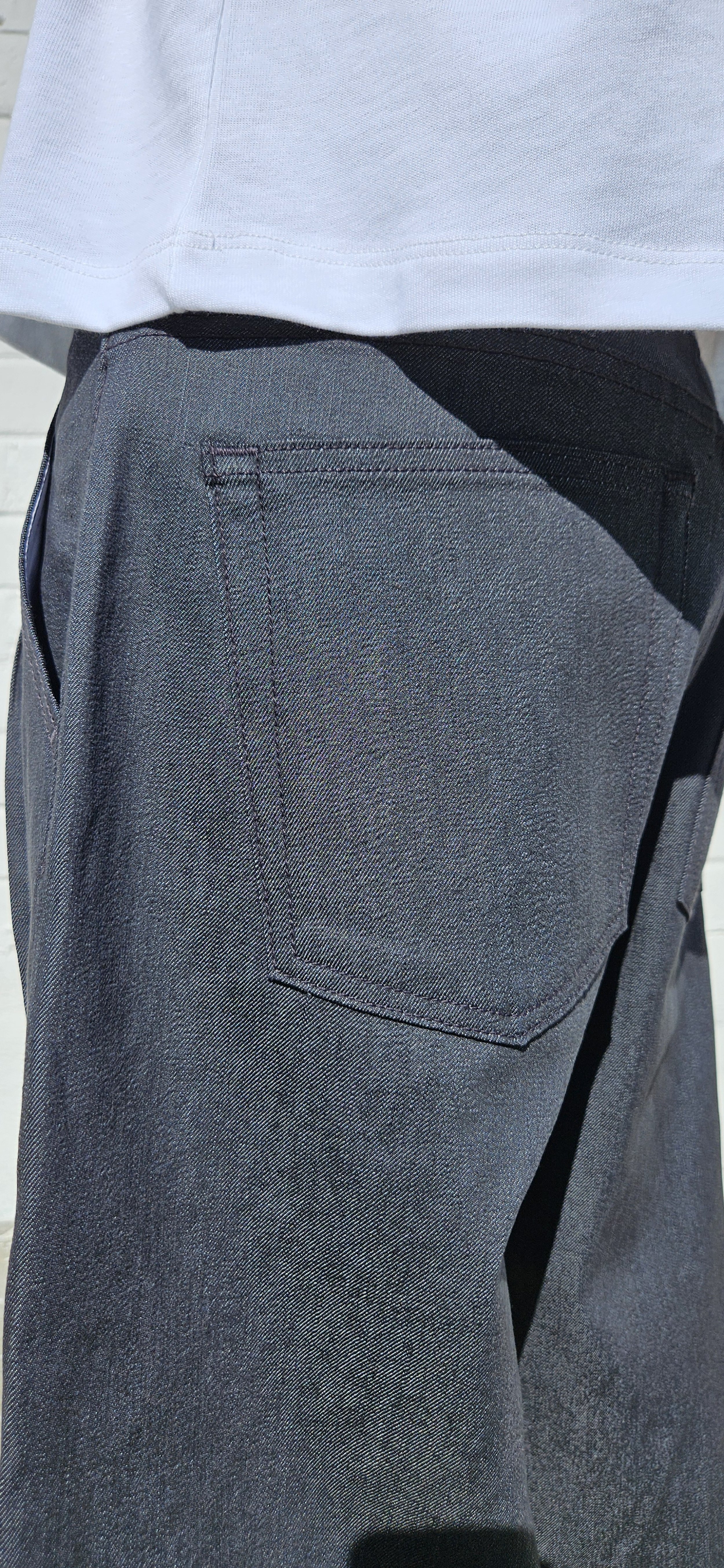 Close up back view of denim charcoal double pleated baggy jeans short